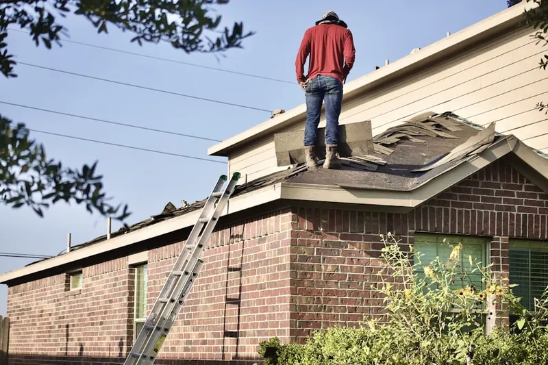 Professional roofer working on a residential roof in Meadowglen